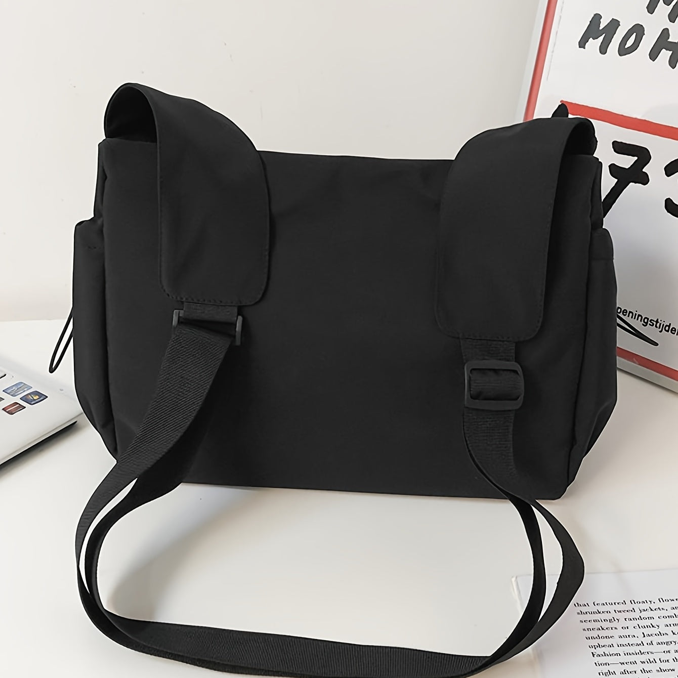 Side view of women's shoulder bag with adjustable crossbody strap