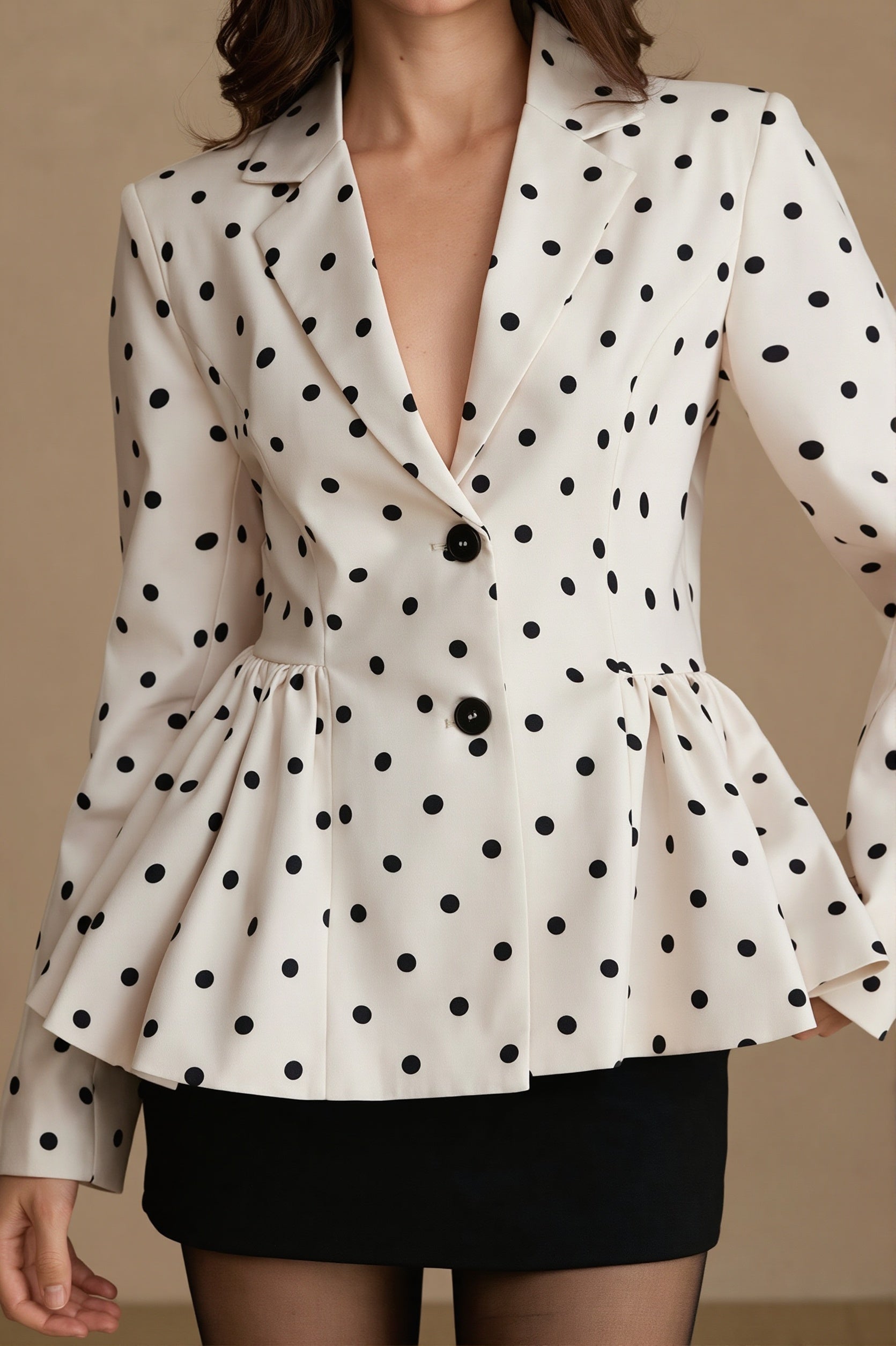 Close-up of the polka dot pattern on a women's peplum blazer