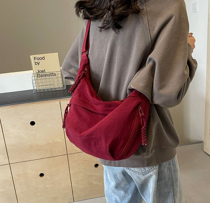 Back view of women's nylon crossbody bag with adjustable shoulder strap