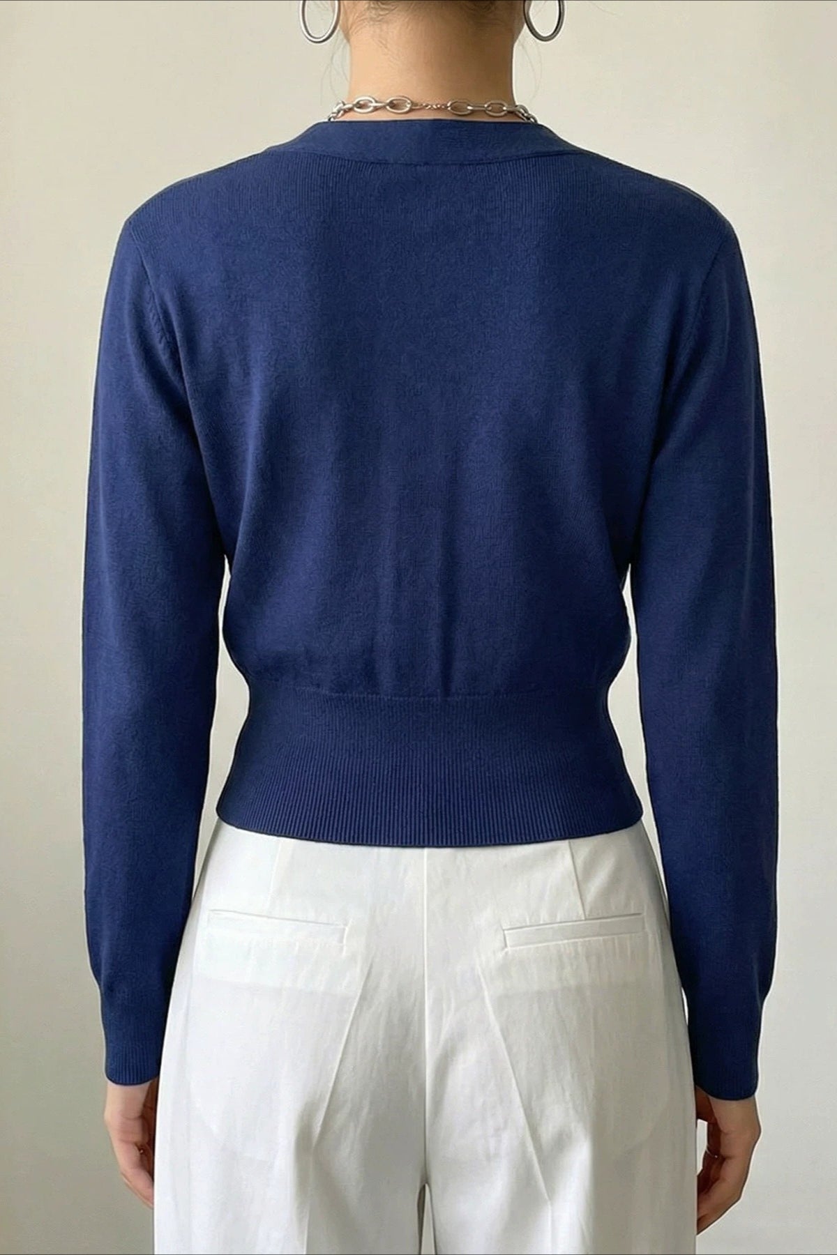 Close-up of the cardigan's double metal button fastening