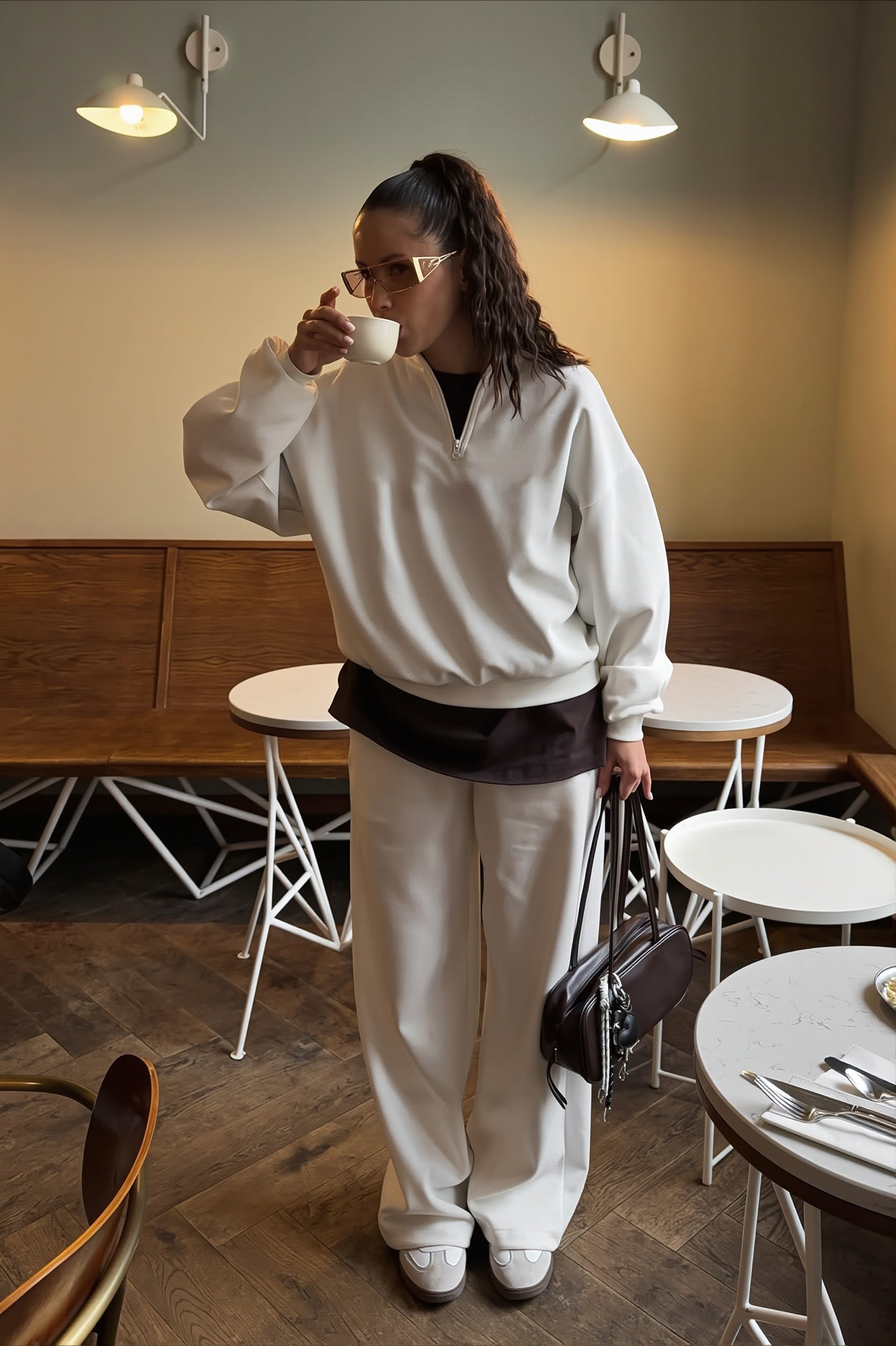 Side view showing the oversized fit of the sweatshirt and pants