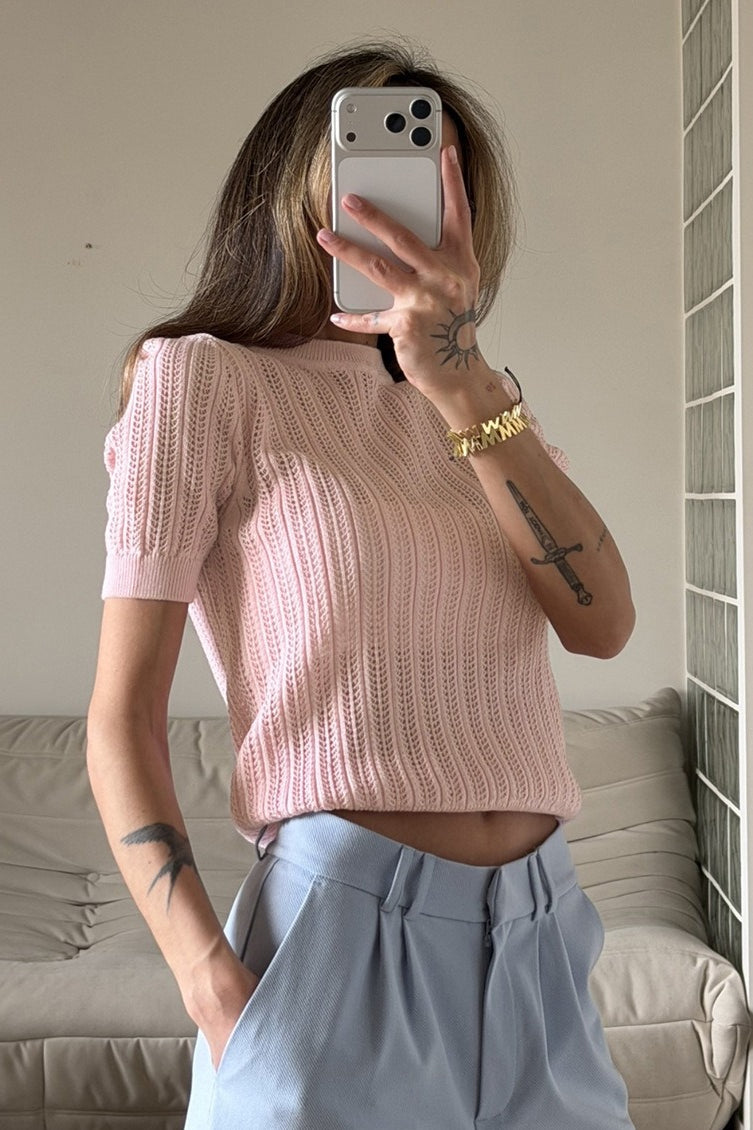 Back view of an openwork crewneck sweater