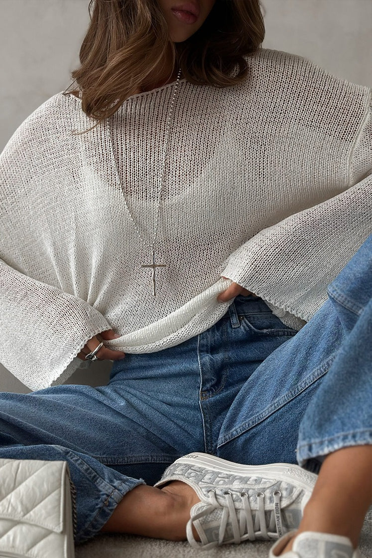 Close-up view of the open-knit texture on a women's sweater