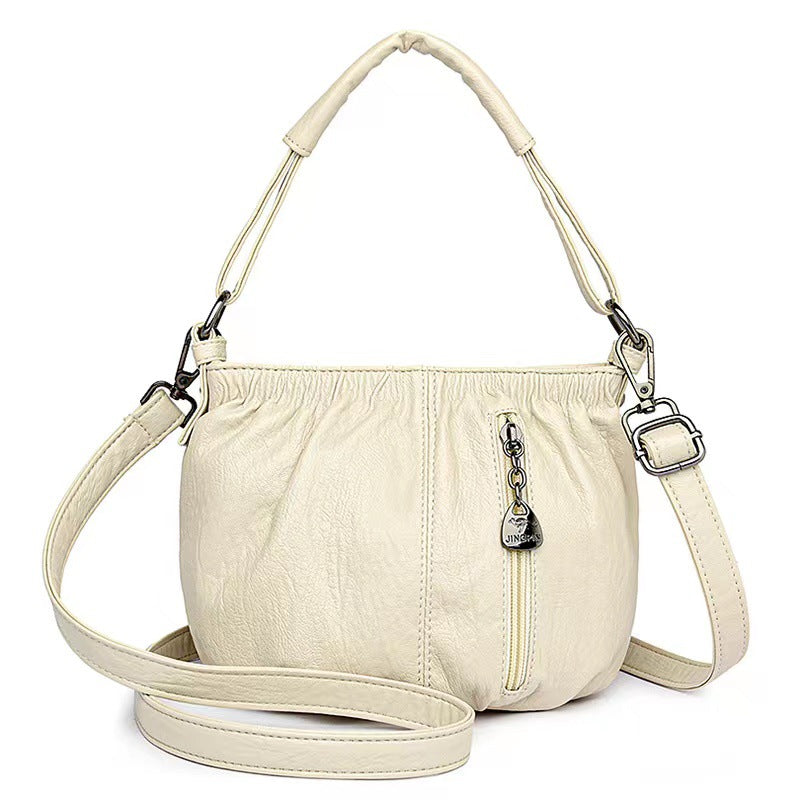Women's crossbody shoulder bag with top zipper closure and front pockets