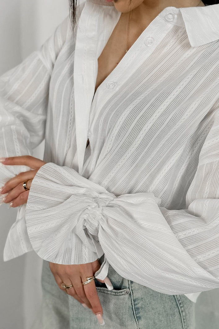 Full view of the sheer striped ruffle cuff shirt on a model