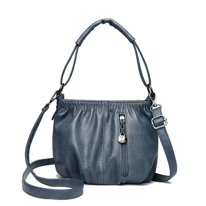 Close-up of zipper pocket details on women's crossbody shoulder bag