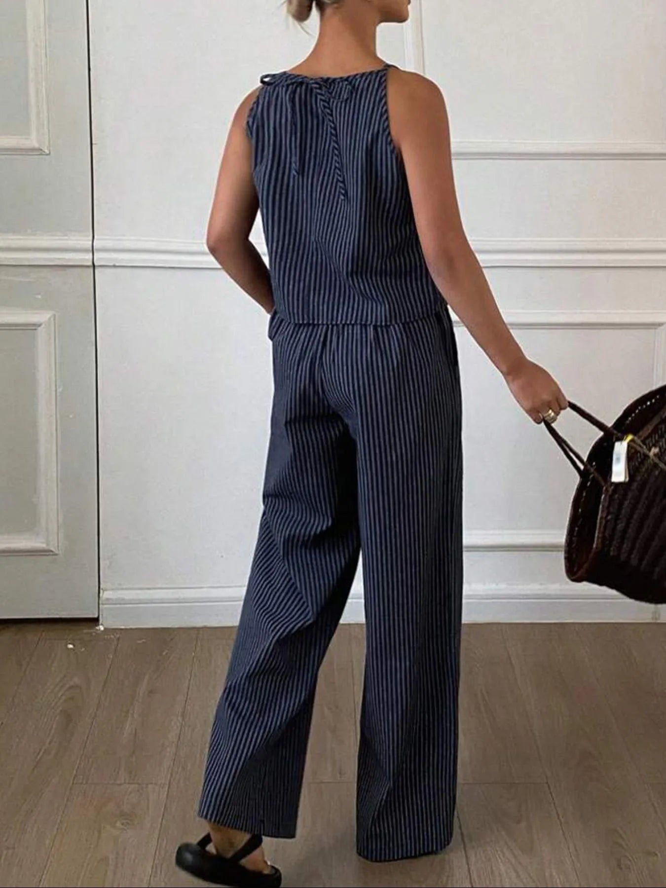 Front view of a striped tank top and wide-leg pants outfit
