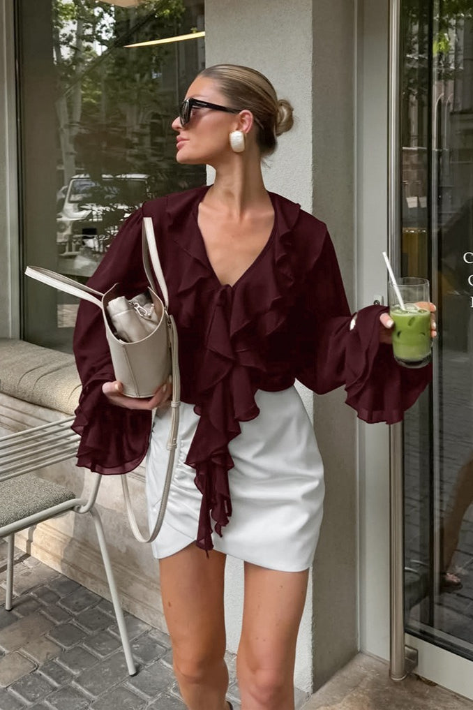Front view of a women's ruffle tie-neck blouse