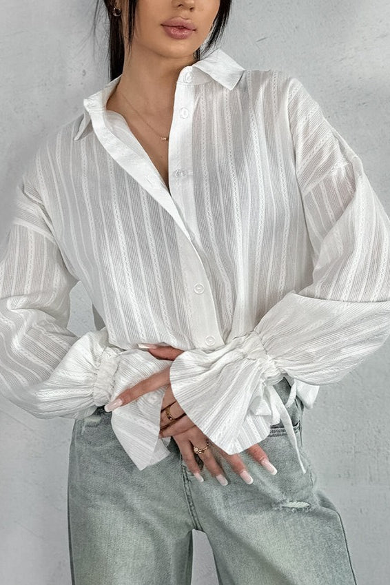 Sheer striped shirt with feminine ruffle cuffs shown from the front
