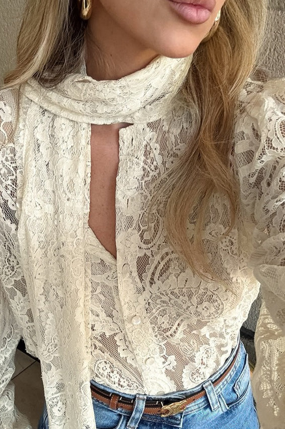 Women's beige lace blouse with a delicate tie-neck scarf detail
