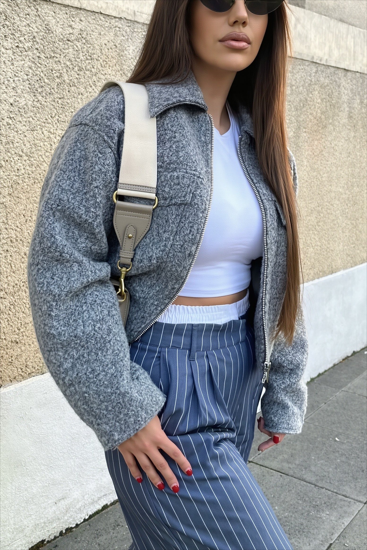 Cropped bouclé jacket highlighting its textured fabric and structured shape
