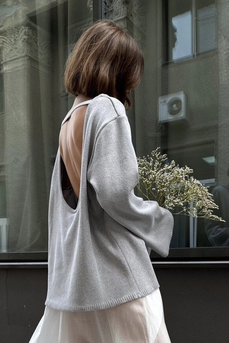 Open-back knit sweater showing the boat neckline and relaxed fit
