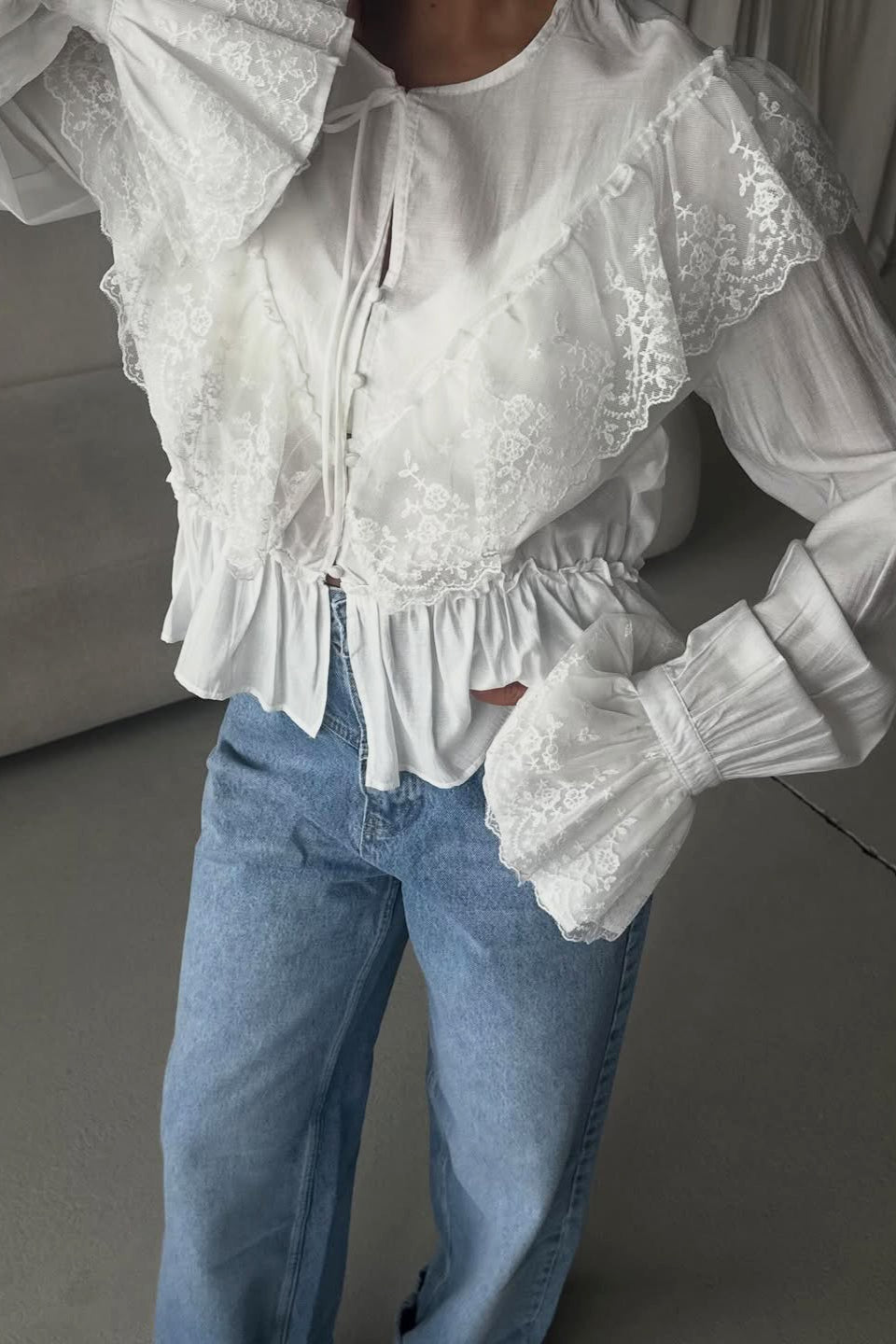 Back view of a lace yoke ruffle hem blouse