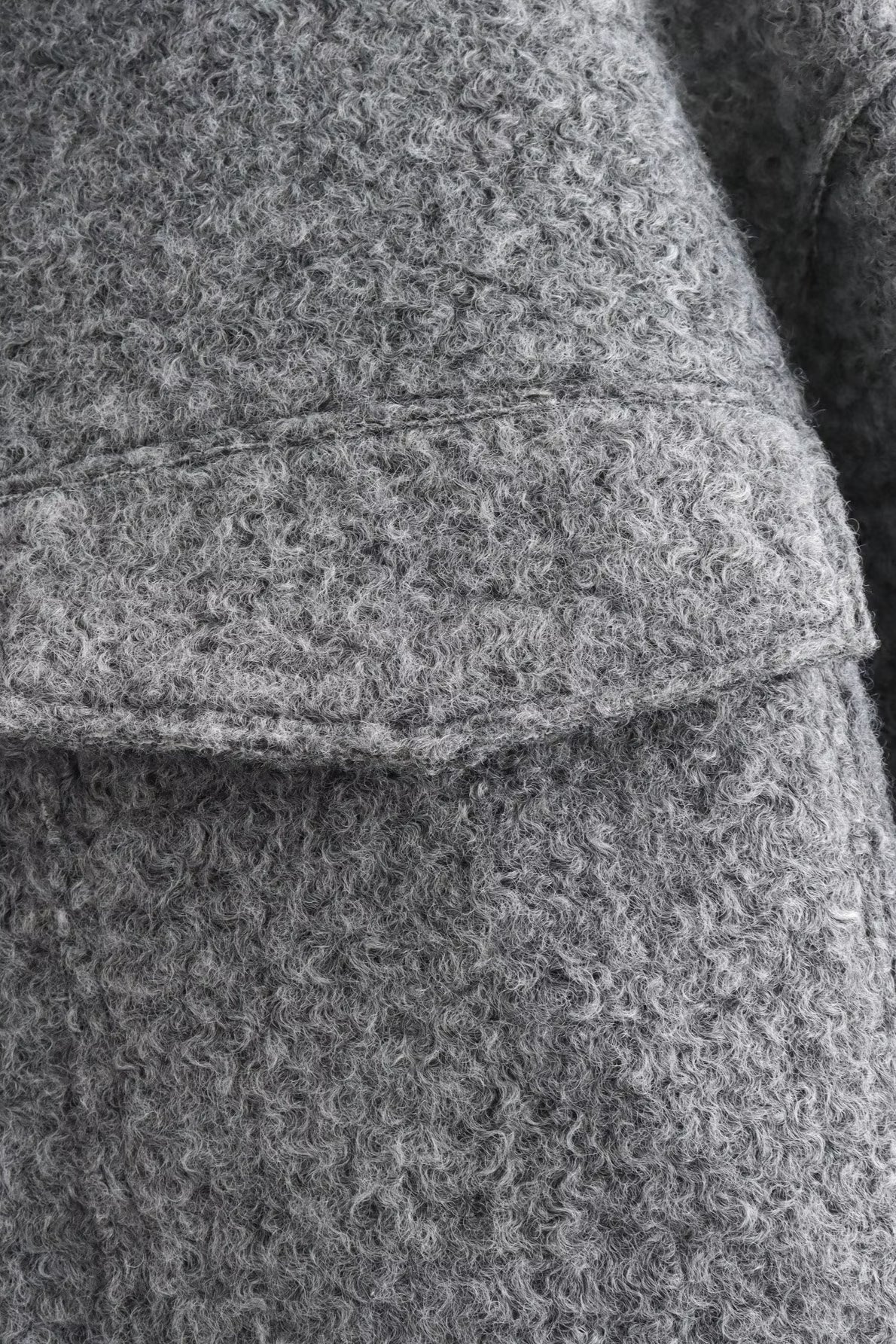 Full product view of the textured cropped jacket with front zip detail