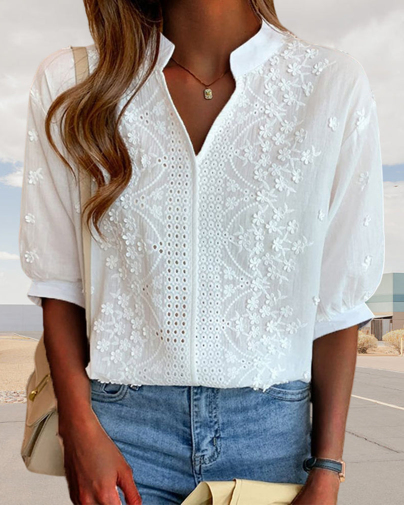 Close-up of the blouse's refined neckline and puff sleeve detail
