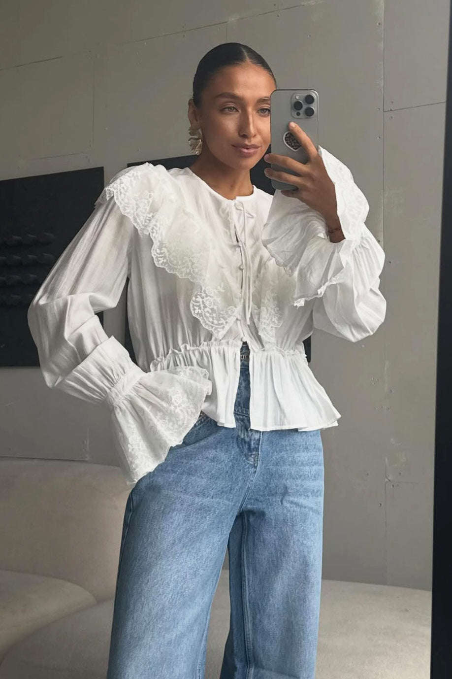 Women's blouse styled with a feminine ruffle hem