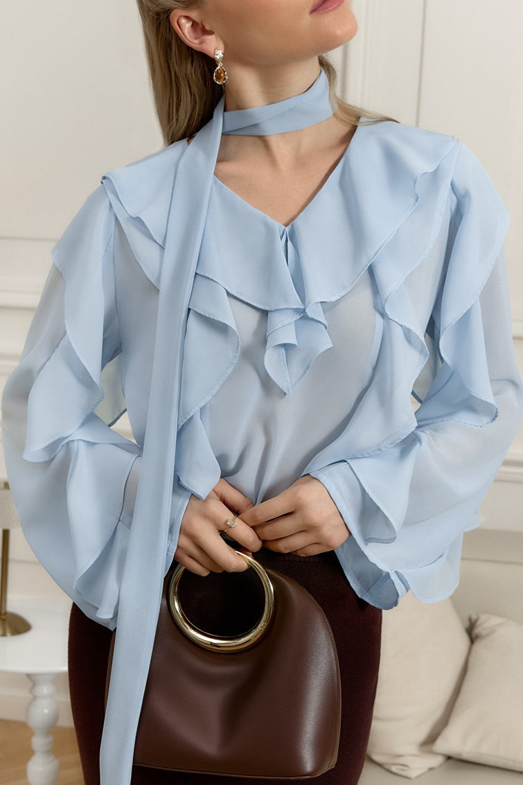 Blouse featuring a ruffle front and tied scarf detail at the neckline