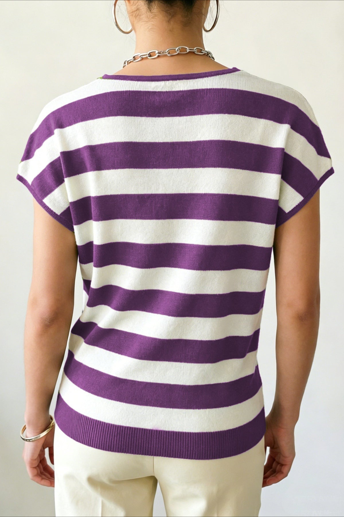 Side view of a striped cardigan showing its short sleeves and wrap design