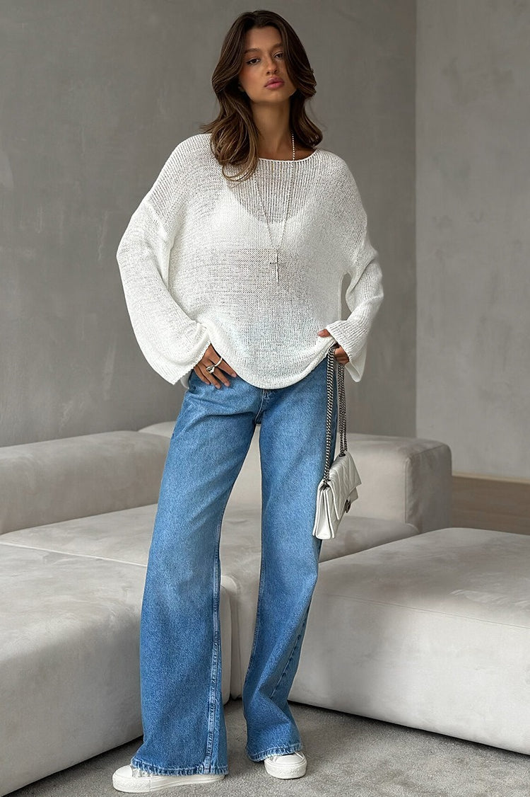 Side view of a women's open-knit off-shoulder sweater