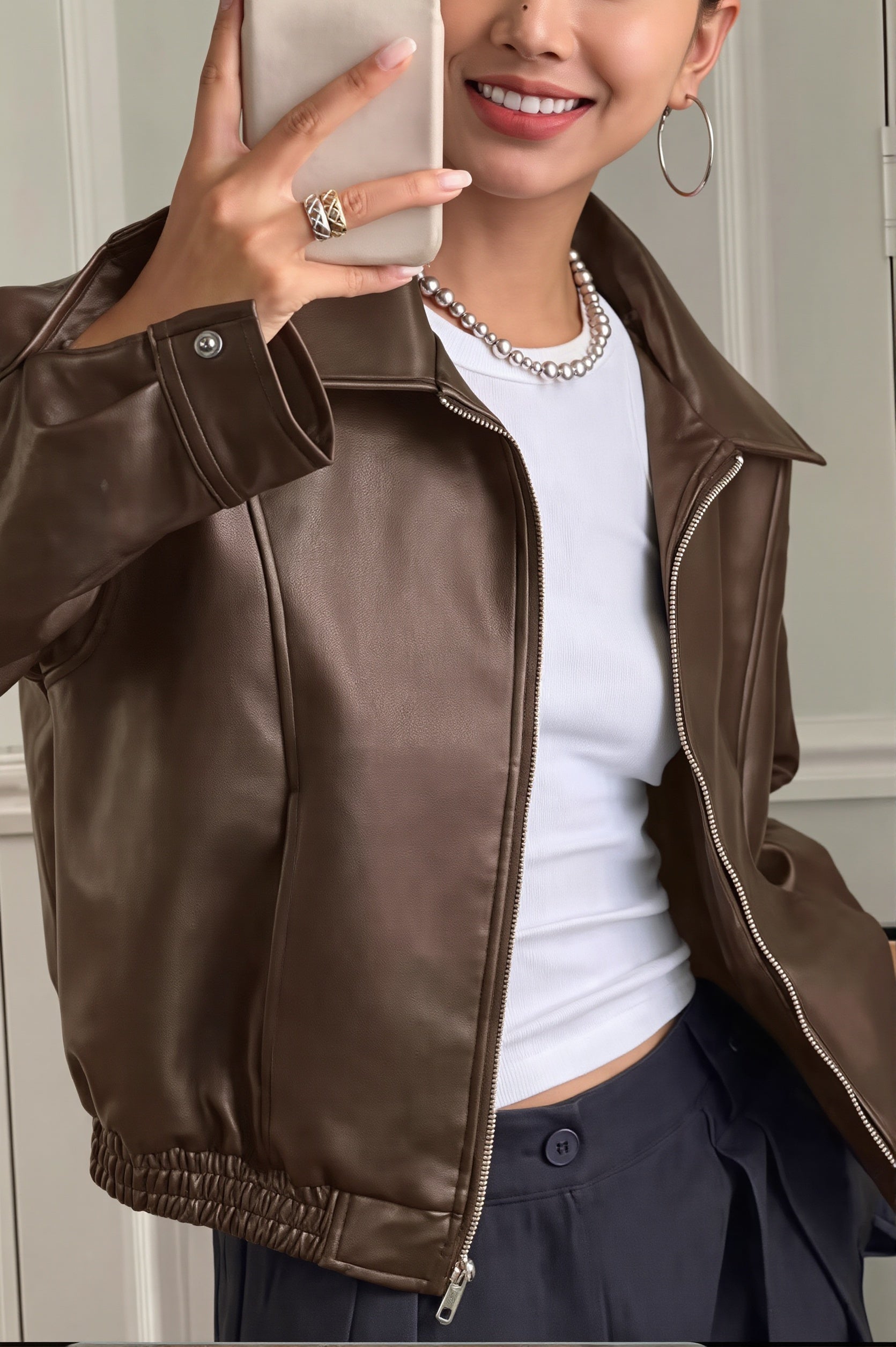 Back view of the cropped faux leather jacket with a clean silhouette