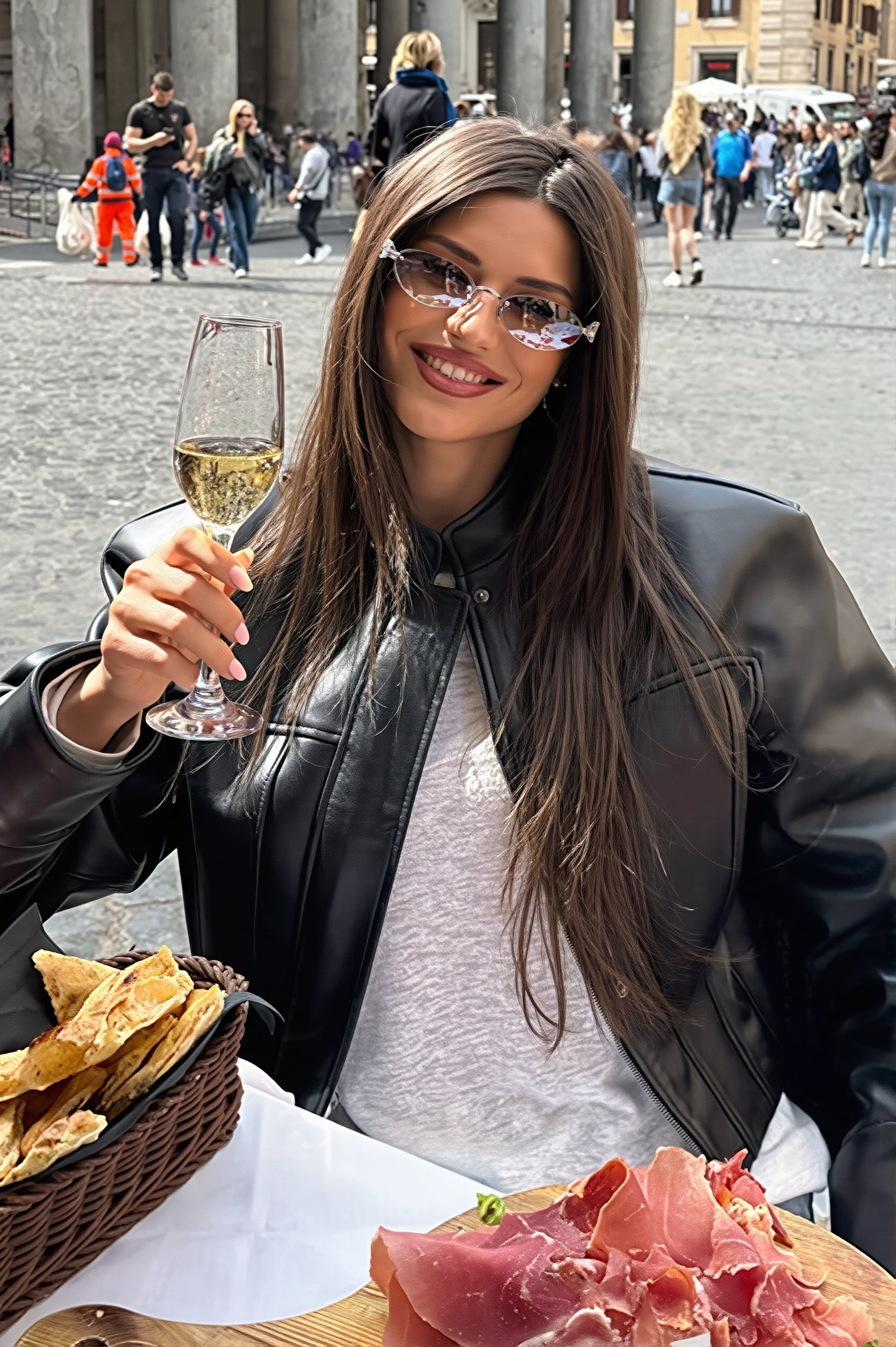 Front view of a faux leather bomber jacket with snap closure