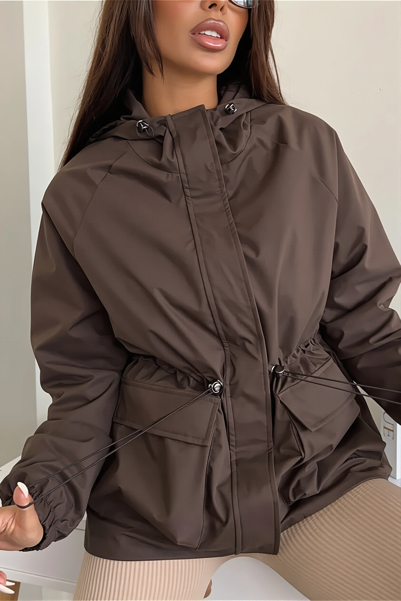 Hooded utility jacket with a drawstring waist shown from the front