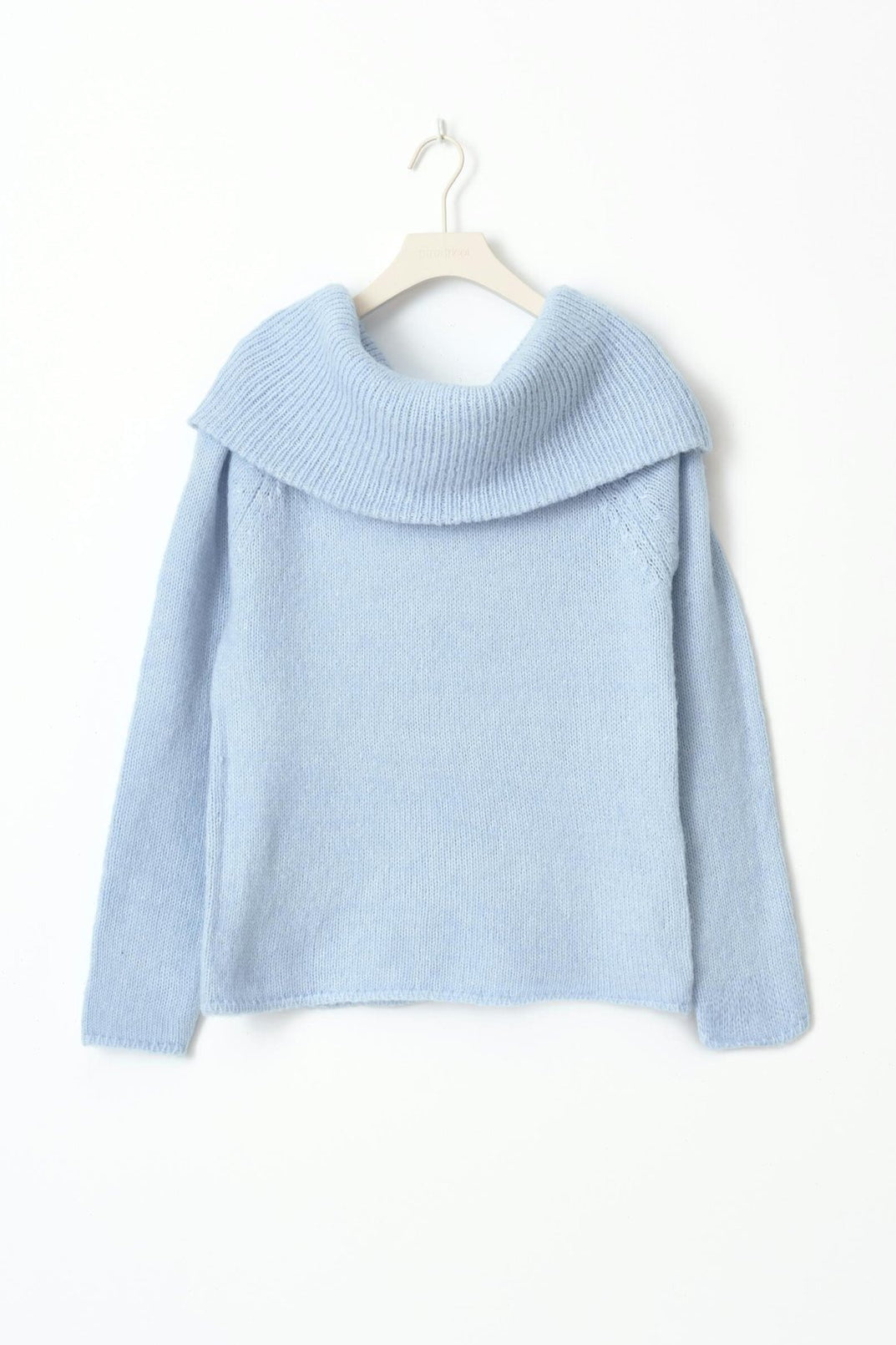 Full-length view of the fitted sweater styled for cool-weather wear