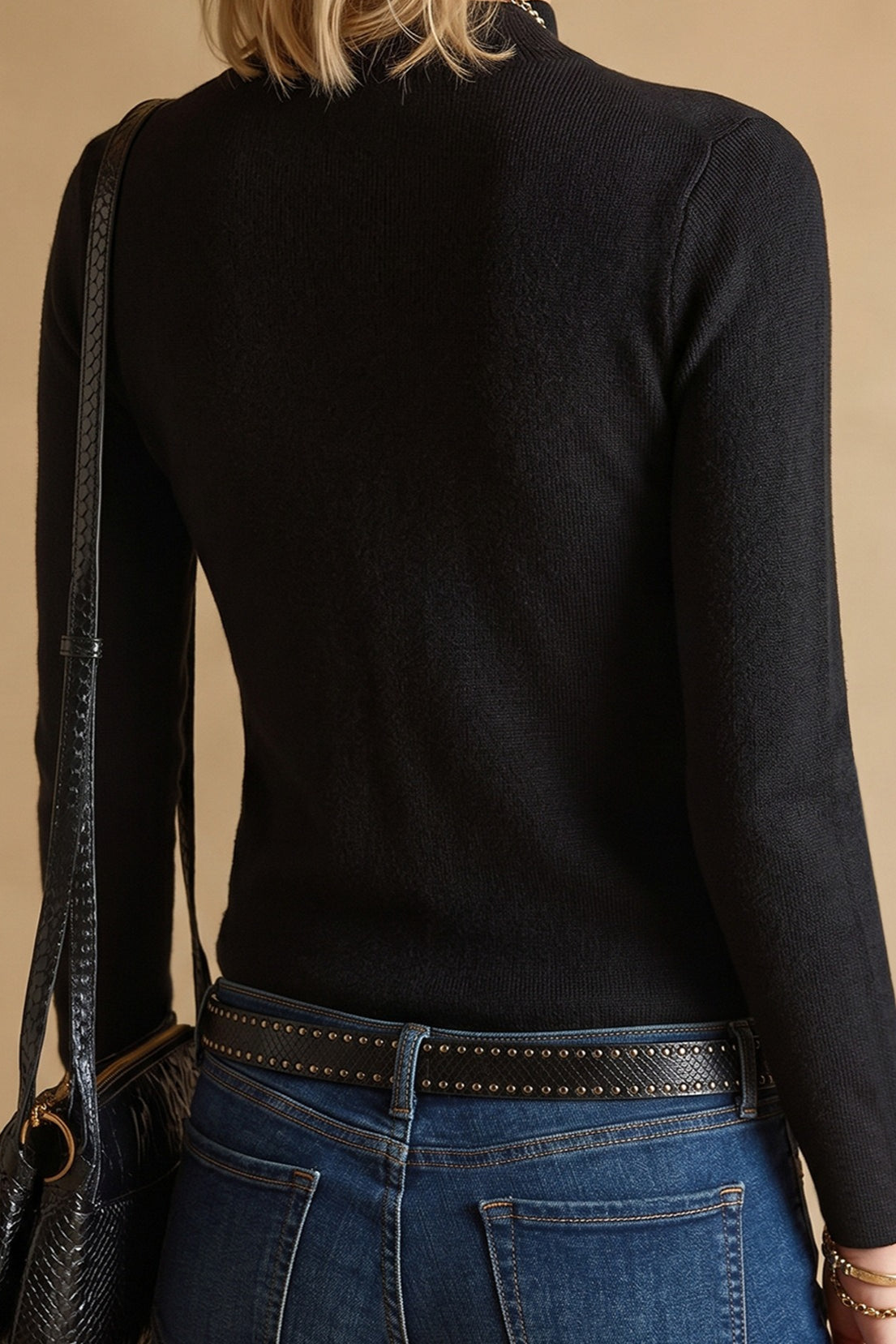 Side view showing the fit and long sleeves of the women's knit sweater