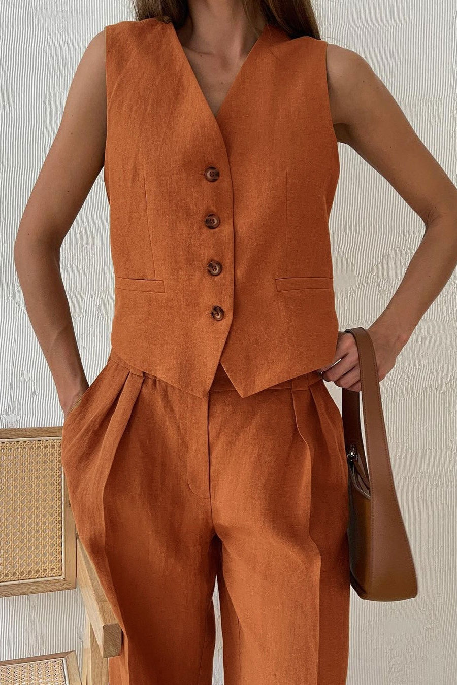 Side view of the low-rise pants and button vest set