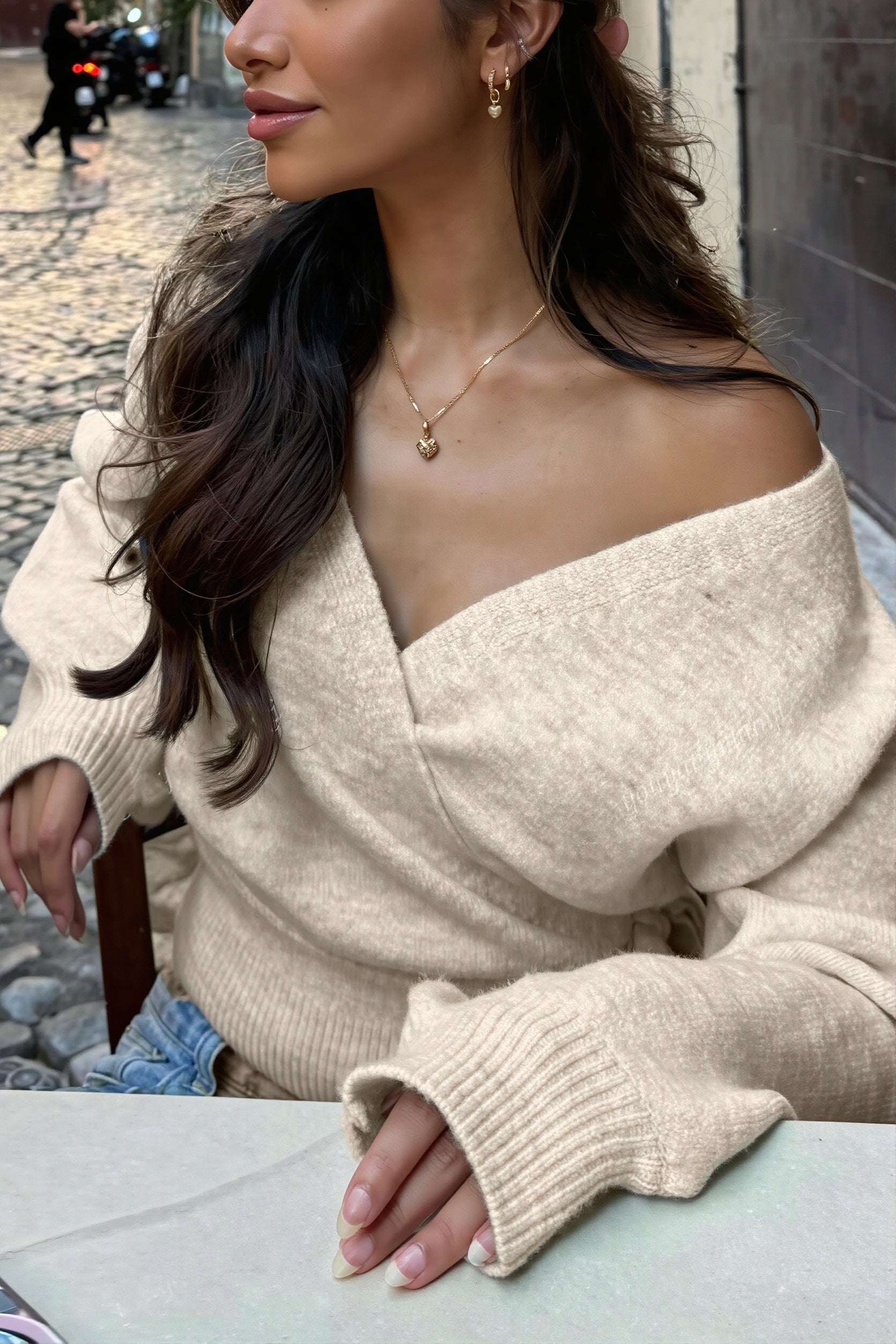 Side view of a women's cropped wrap sweater with a tie waist.