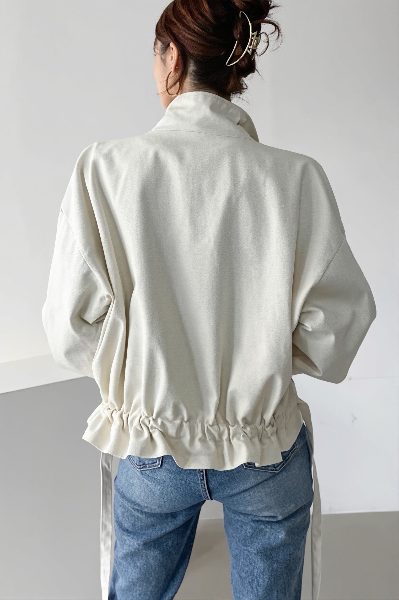 Oversized utility jacket highlighting its practical front pockets