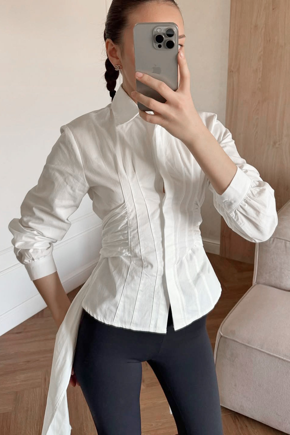 Side view of a women's ruched waist tie-back shirt