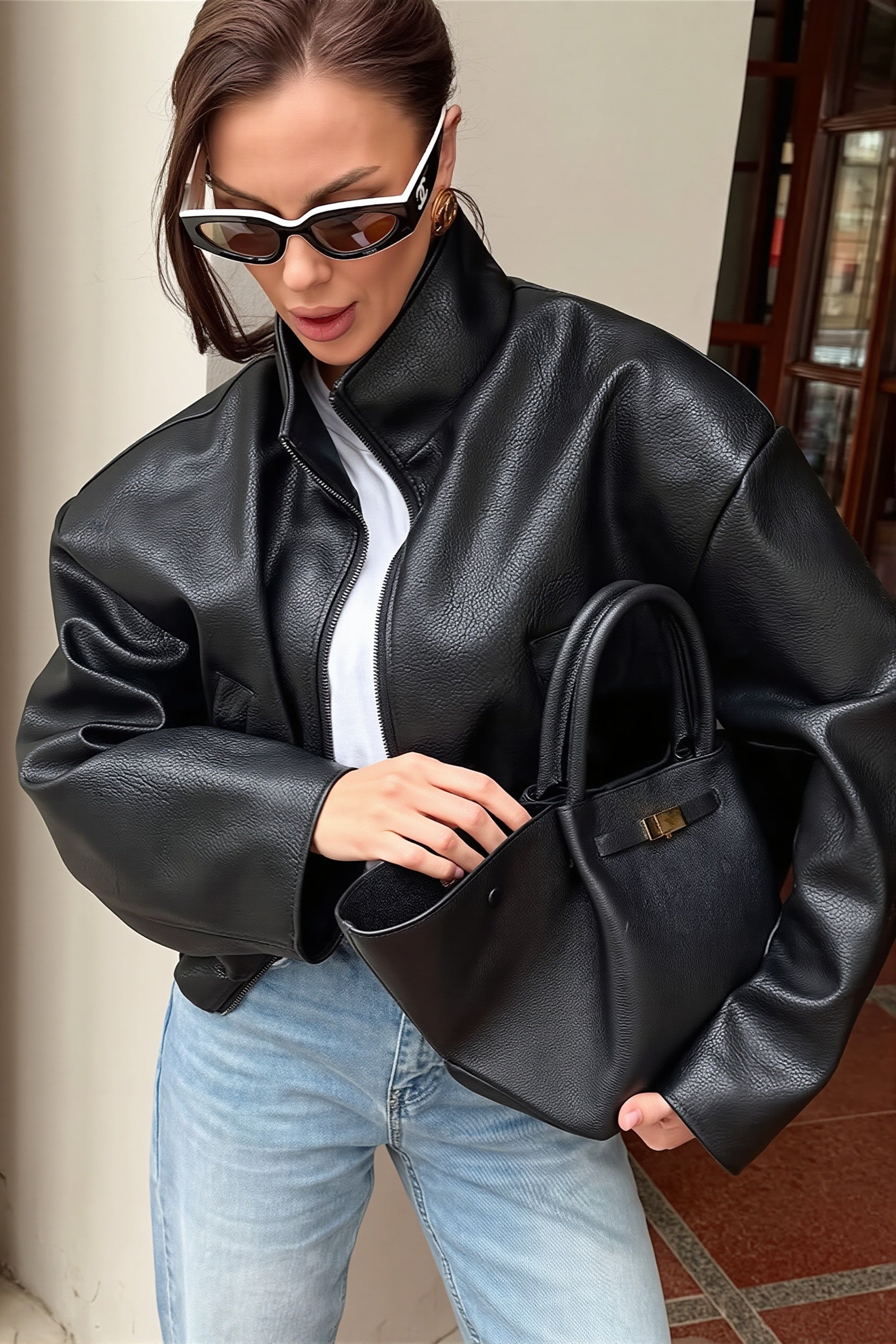 Cropped faux leather jacket with a structured stand collar shown from the front