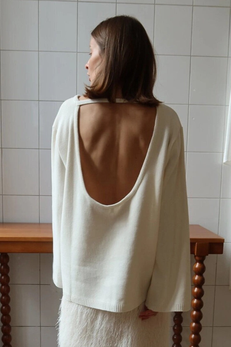 Open-back knit sweater styled as a versatile everyday layer