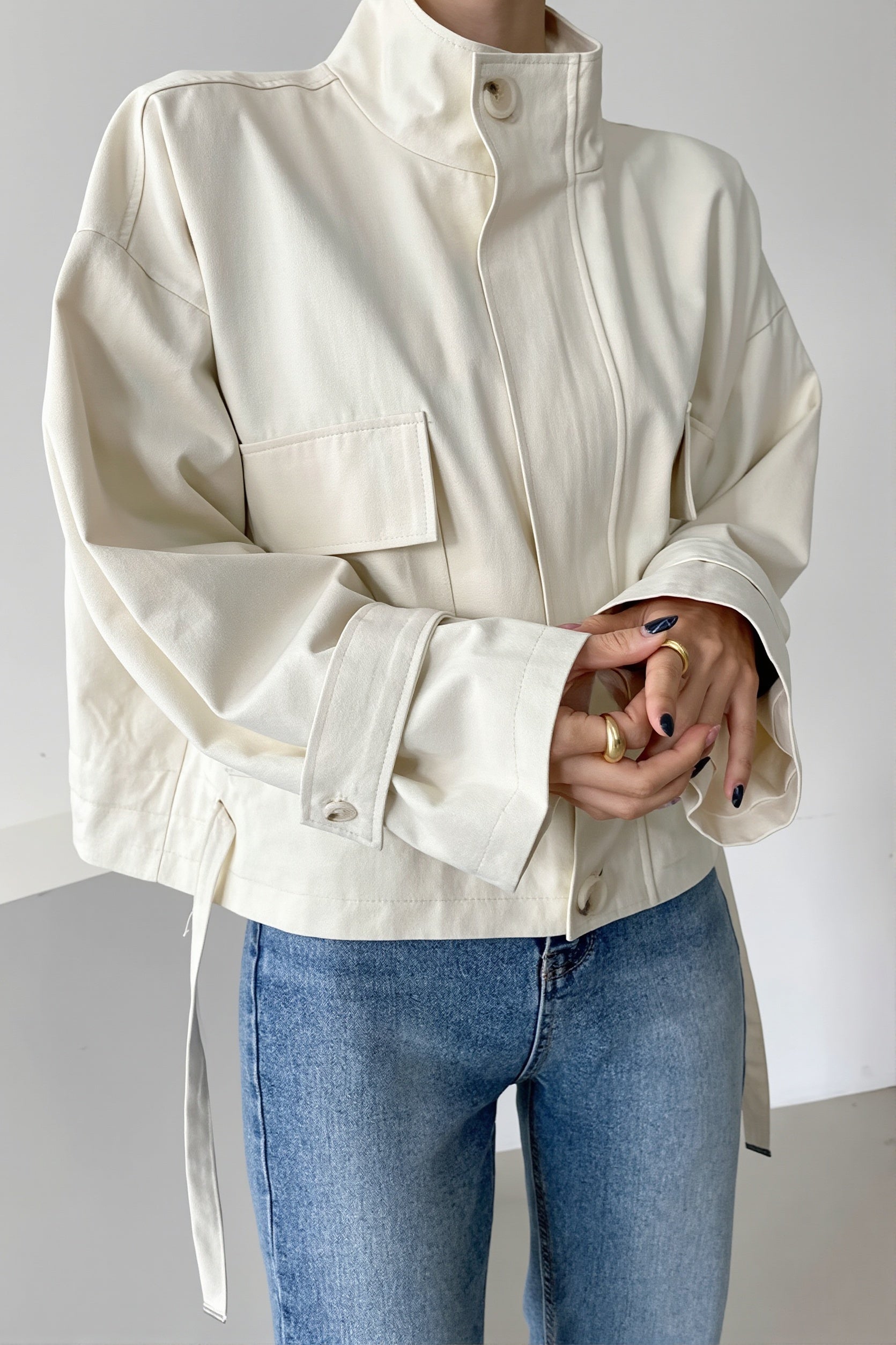 Close-up of the stand collar and front closure on the utility jacket