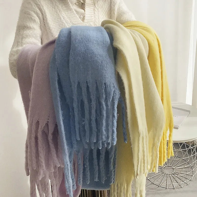 Close-up of the scarf's soft woven texture and solid-color finish