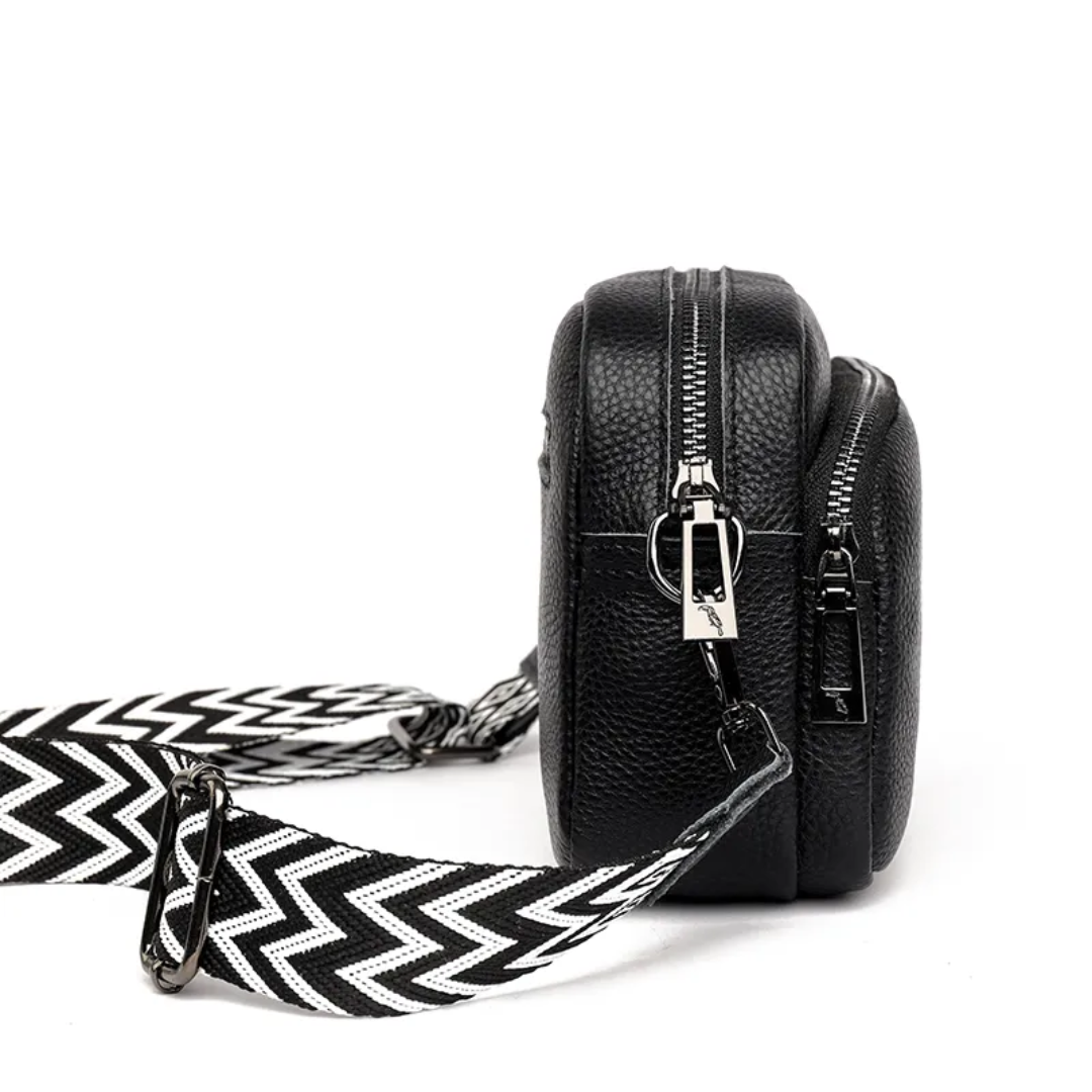 Women's structured leather messenger bag with flap closure and adjustable strap
