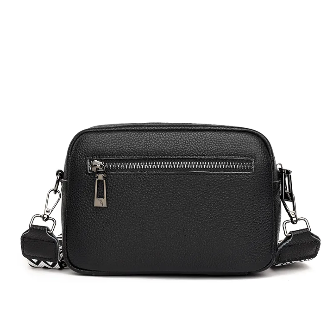 Side view of women's leather messenger bag with adjustable crossbody strap