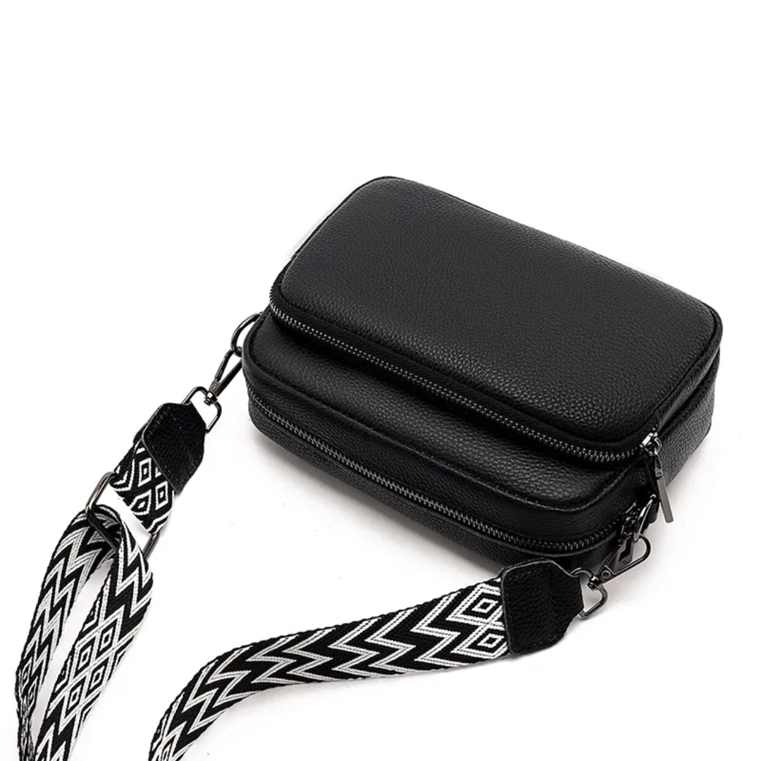 Back view of modern women's leather messenger bag in smooth leather