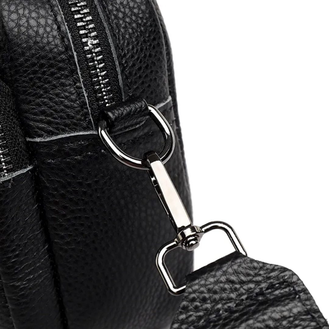 Close-up of leather texture and flap on women's messenger bag