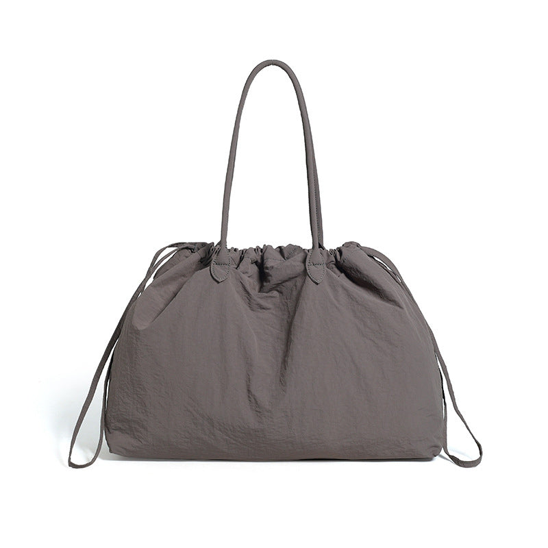 Water-resistant drawstring tote bag shown from the front