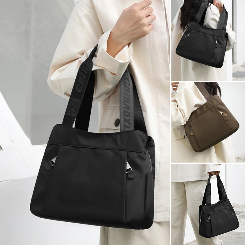 Angled view of lightweight nylon crossbody bag with adjustable strap and zip pockets