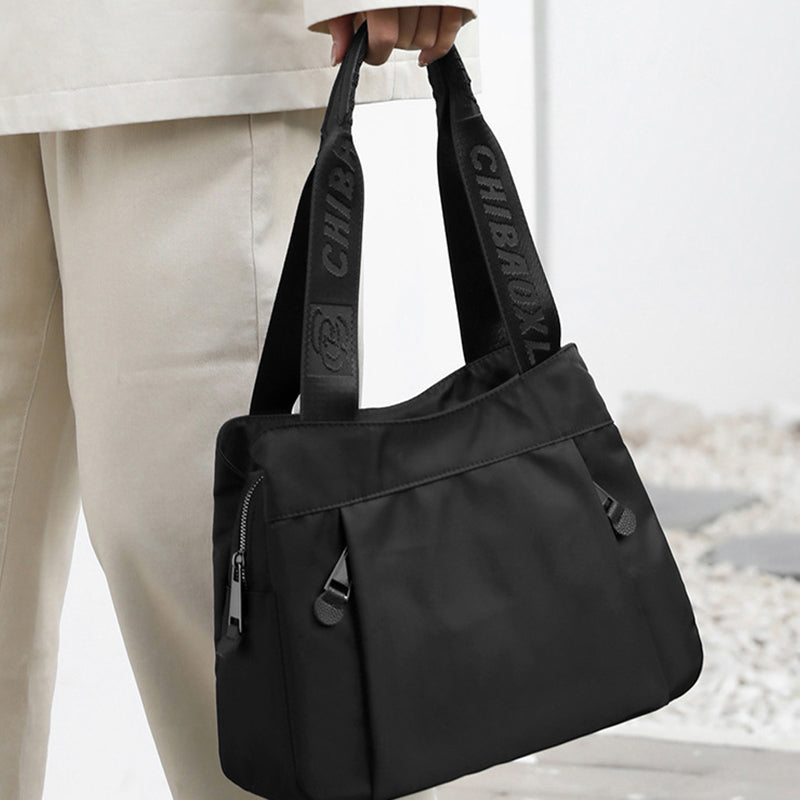 Nylon crossbody bag styled for everyday use with multiple compartments visible