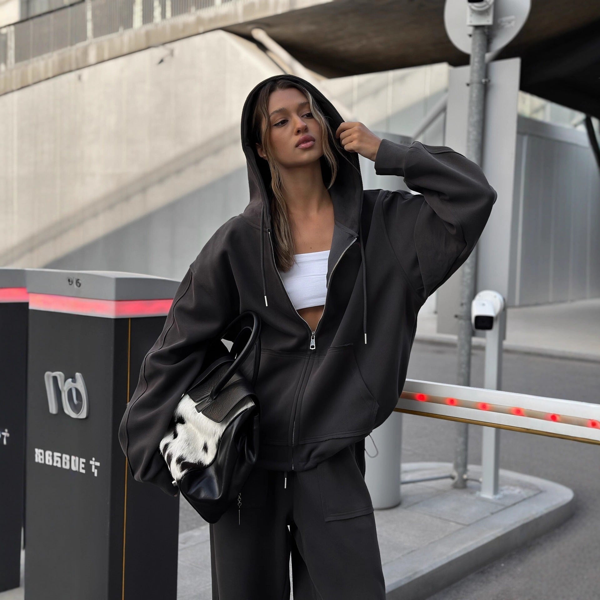 Side view of a women's oversized zip-up hoodie jacket