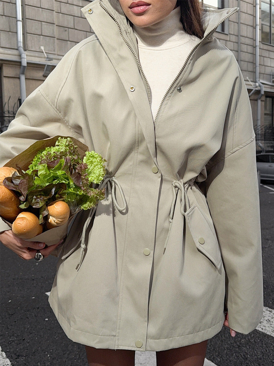 Side view of a stand collar field jacket with an adjustable waist