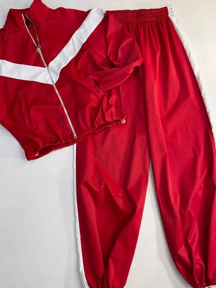 Women's satin track suit top and pants shown as a coordinated matching set