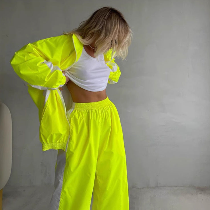 Side view of a women's windbreaker tracksuit with relaxed wide-leg pants