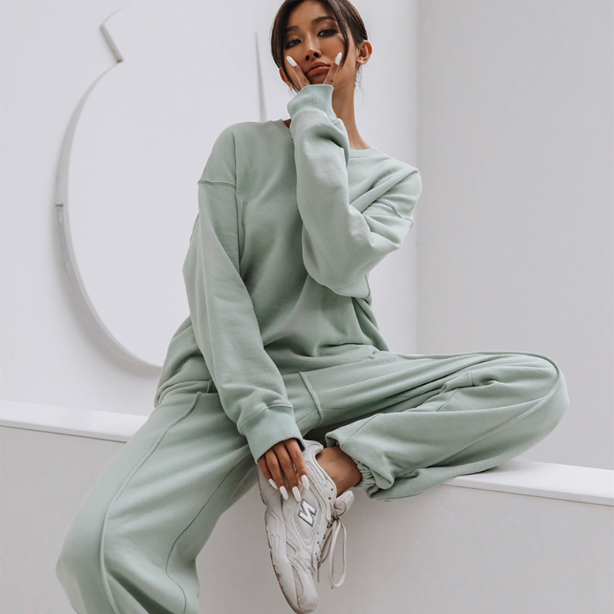 Back view of a coordinated women's sweatshirt and wide-leg pants set