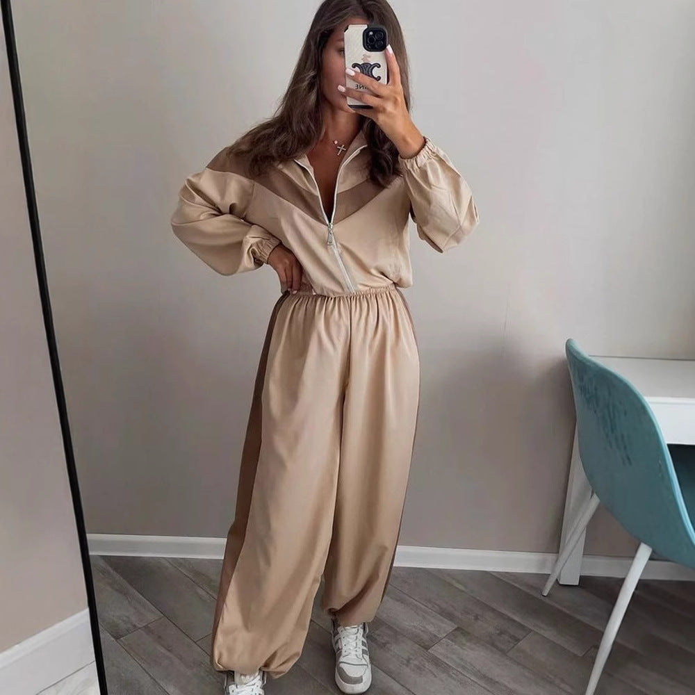 Side view of a women's satin track suit with a relaxed fit and drawstring detail