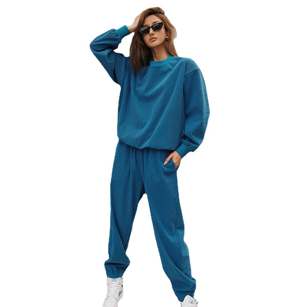 Side view of a women's matching corduroy tracksuit set with jogger pants